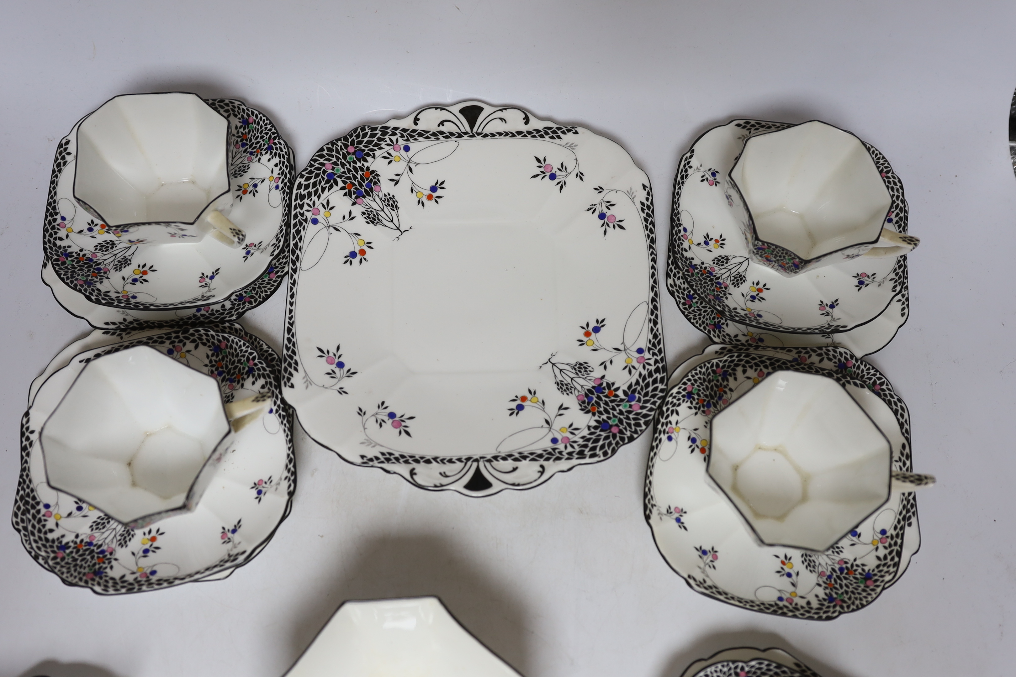 A Shelley Black Leafy Tree pattern part tea set comprising trios, milk jug, bowl and sandwich plate